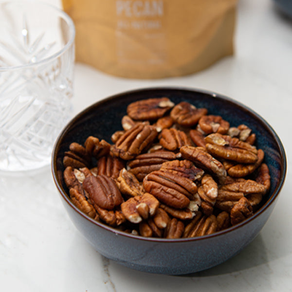 Roasted pecans from Fresh Nuts in a 0.25 kg pack, showing golden-brown, crunchy nuts on a white background.