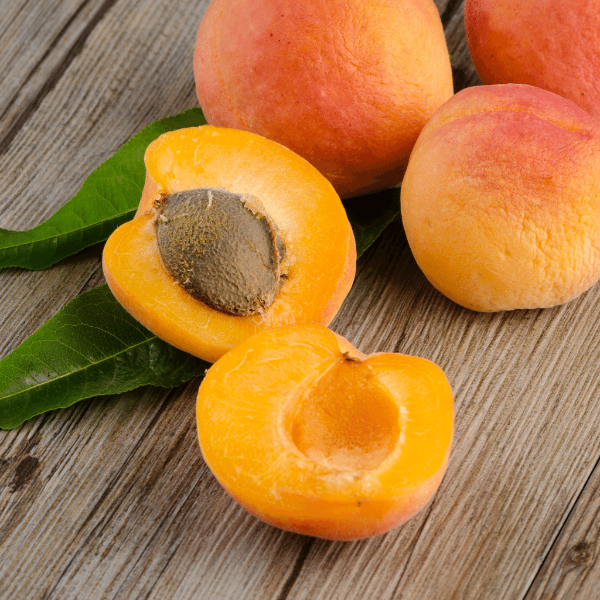 Fresh Sharbatly apricots in a 1 kg pack, showcasing ripe, orange fruit with smooth skin and natural shine.