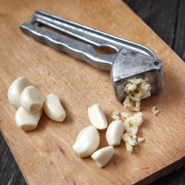 Peeled garlic cloves in a 0.45 kg pack from Sharbatly, fresh vegetable with smooth, white garlic bulbs ready for cooking.