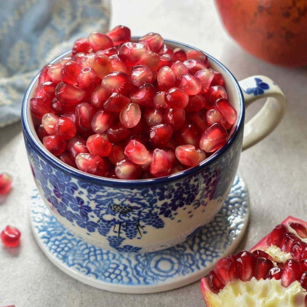 Yemeni pomegranates from Sharbatly, fresh and vibrant red fruit in a 2 kg pack, displayed in a wooden box.